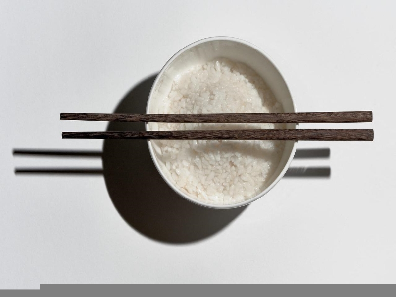 Picking up rice with chopsticks